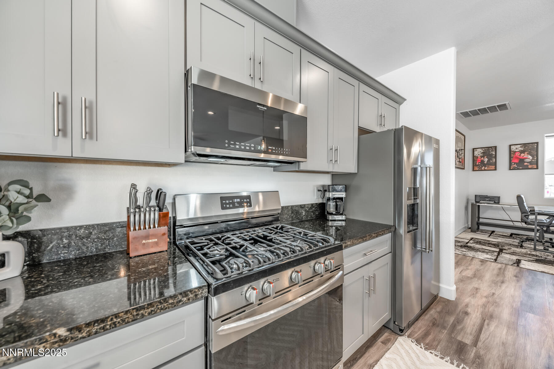 785 Garnet Way Fernley, NV 89408 - Photo 16 of 33 a kitchen with stainless steel appliances granite countertop a stove microwave and refrigerator