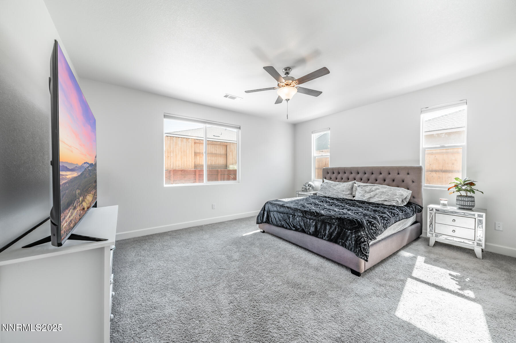 785 Garnet Way Fernley, NV 89408 - Photo 18 of 33 a living room with a bed furniture flat screen tv and a window