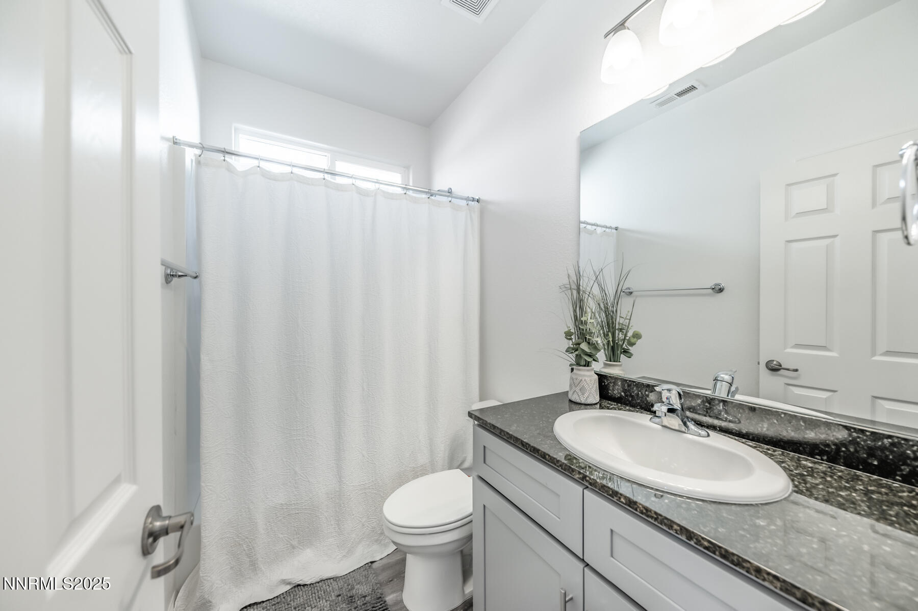 785 Garnet Way Fernley, NV 89408 - Photo 24 of 33 a bathroom with a granite countertop sink toilet and a mirror