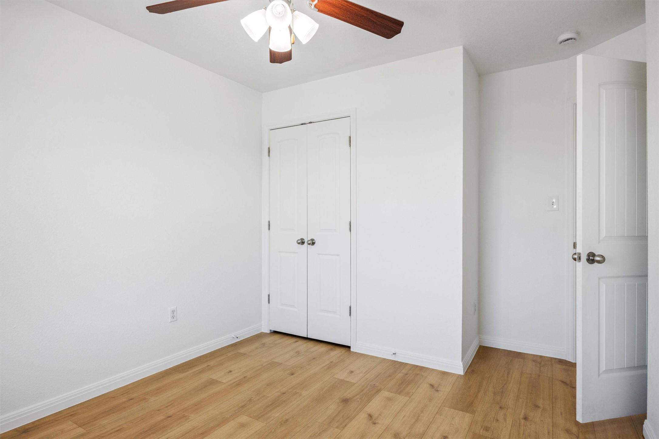 4516 Kind Way, Unit 253 Austin, TX 78725 - Photo 16 of 31 a view of an empty room with wooden floor