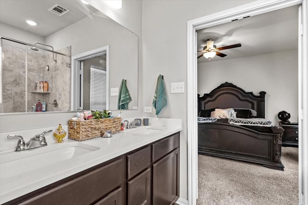 3501 Beutel Road Lorena, TX 76655 - Photo 14 of 33 Full bathroom featuring ensuite bathroom, double vanity, tiled shower, and ceiling fan