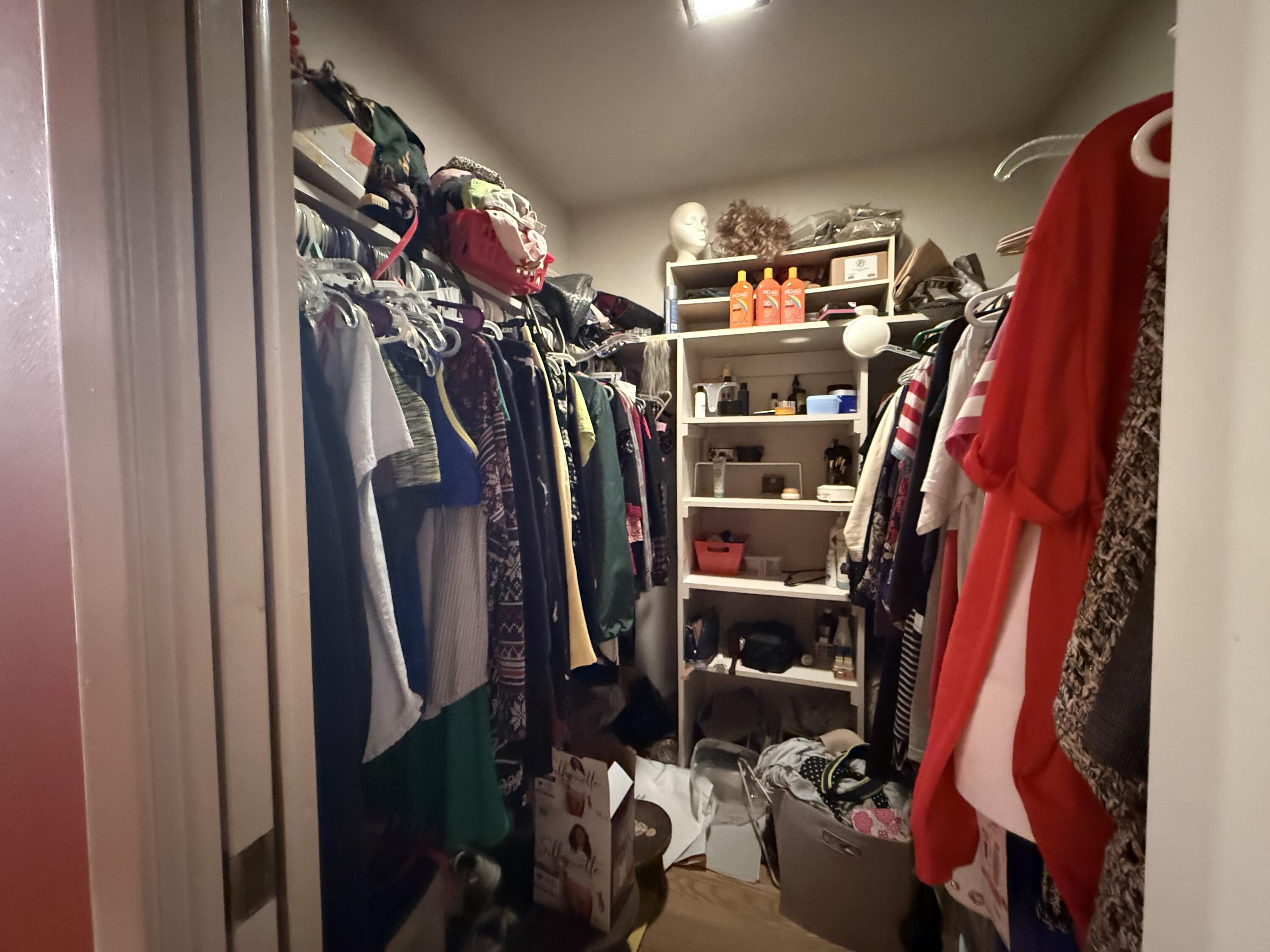 43 12th Avenue Shalimar, FL 32579 - Photo 16 of 17 a view of walk in closet with clothes and shoes