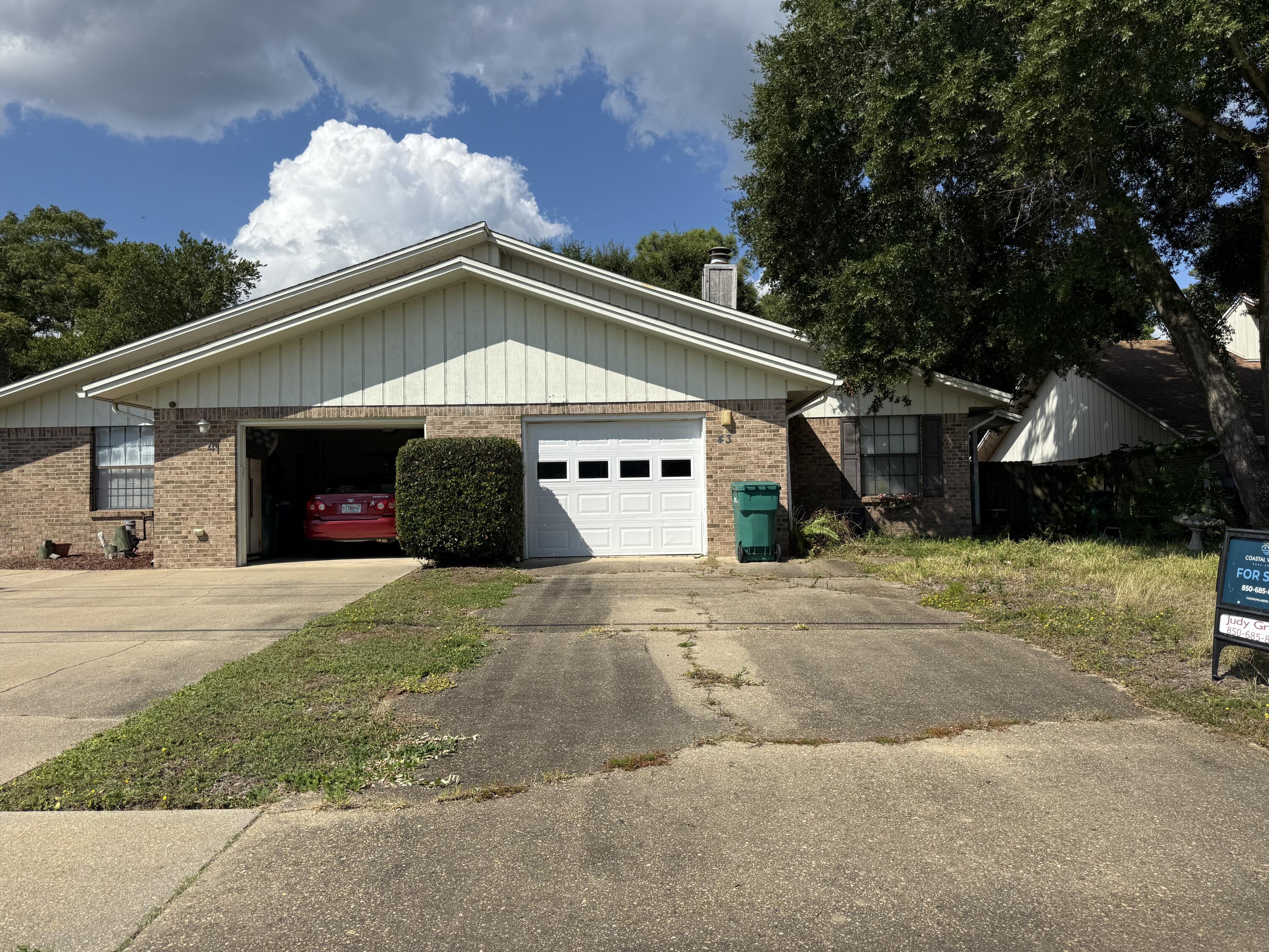 43 12th Avenue Shalimar, FL 32579 - Photo 2 of 17 a view of a house with a yard and garage