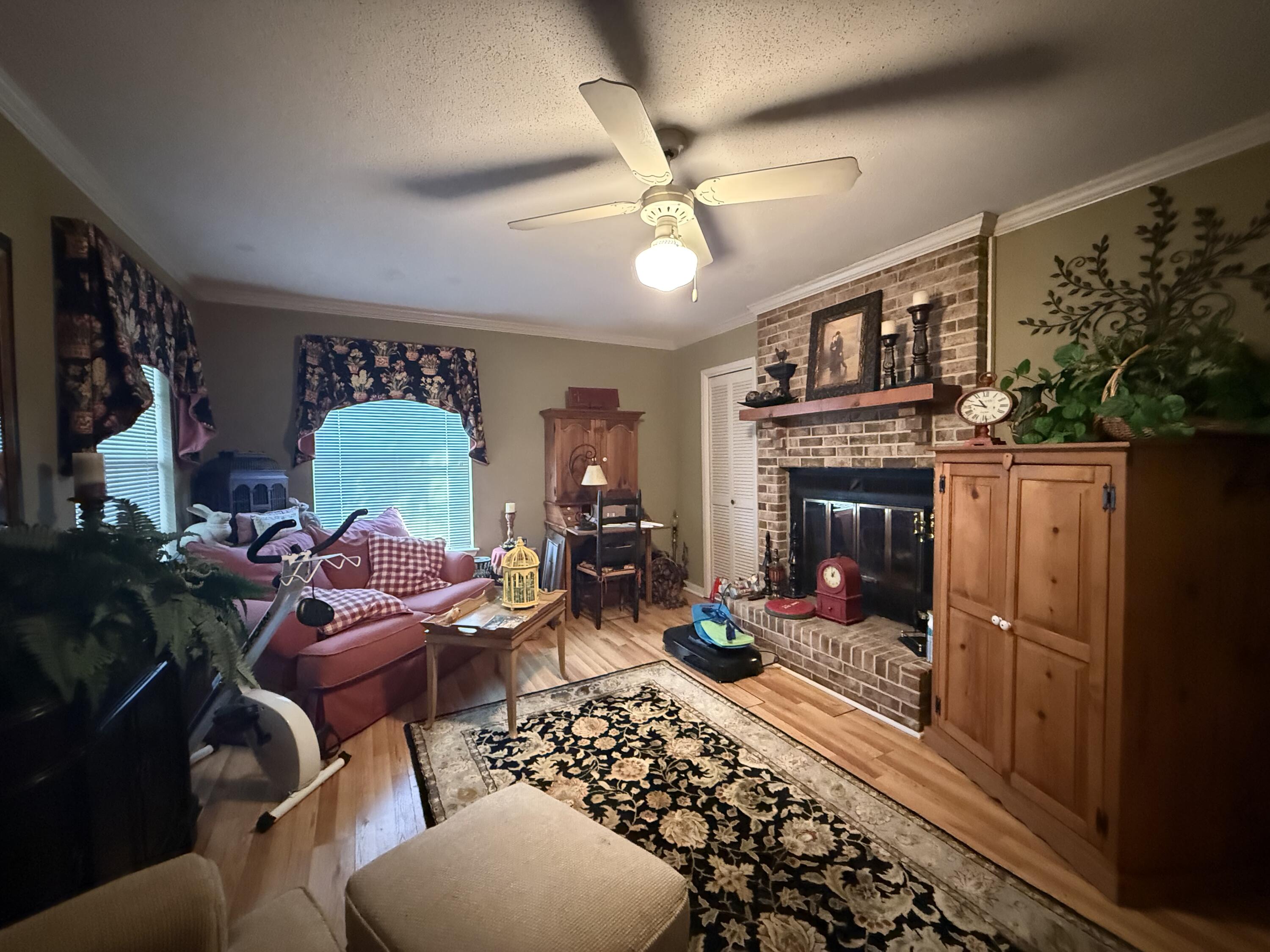 43 12th Avenue Shalimar, FL 32579 - Photo 6 of 17 a living room with furniture a flat screen tv and a fireplace