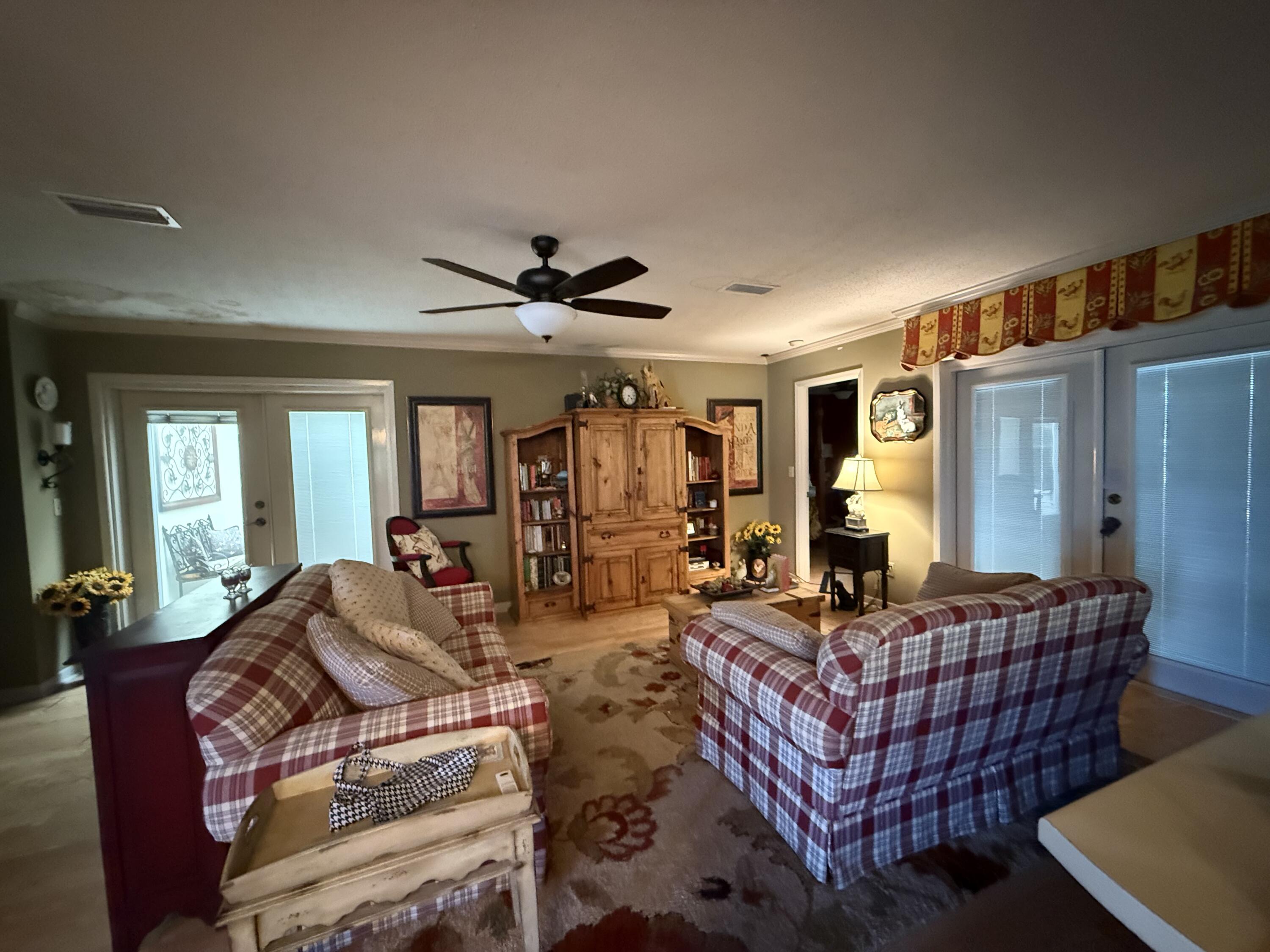 43 12th Avenue Shalimar, FL 32579 - Photo 7 of 17 a living room with furniture ceiling fan and a wooden floor