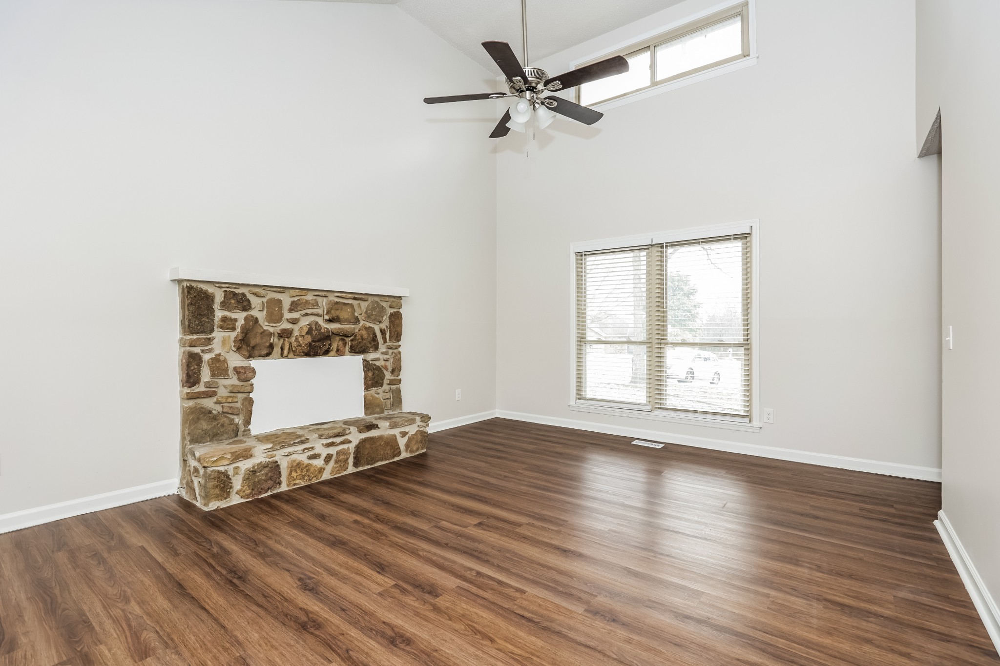 405 Montego Cove Hermitage, TN 37076 - Photo 3 of 16 an empty room with wooden floor fan and windows