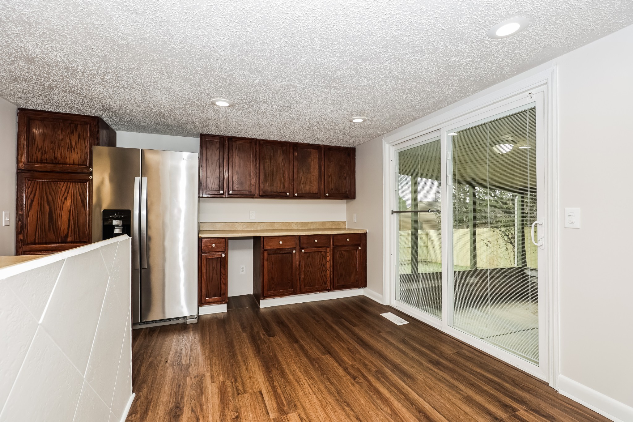 405 Montego Cove Hermitage, TN 37076 - Photo 5 of 16 a kitchen with granite countertop a refrigerator and a stove top oven