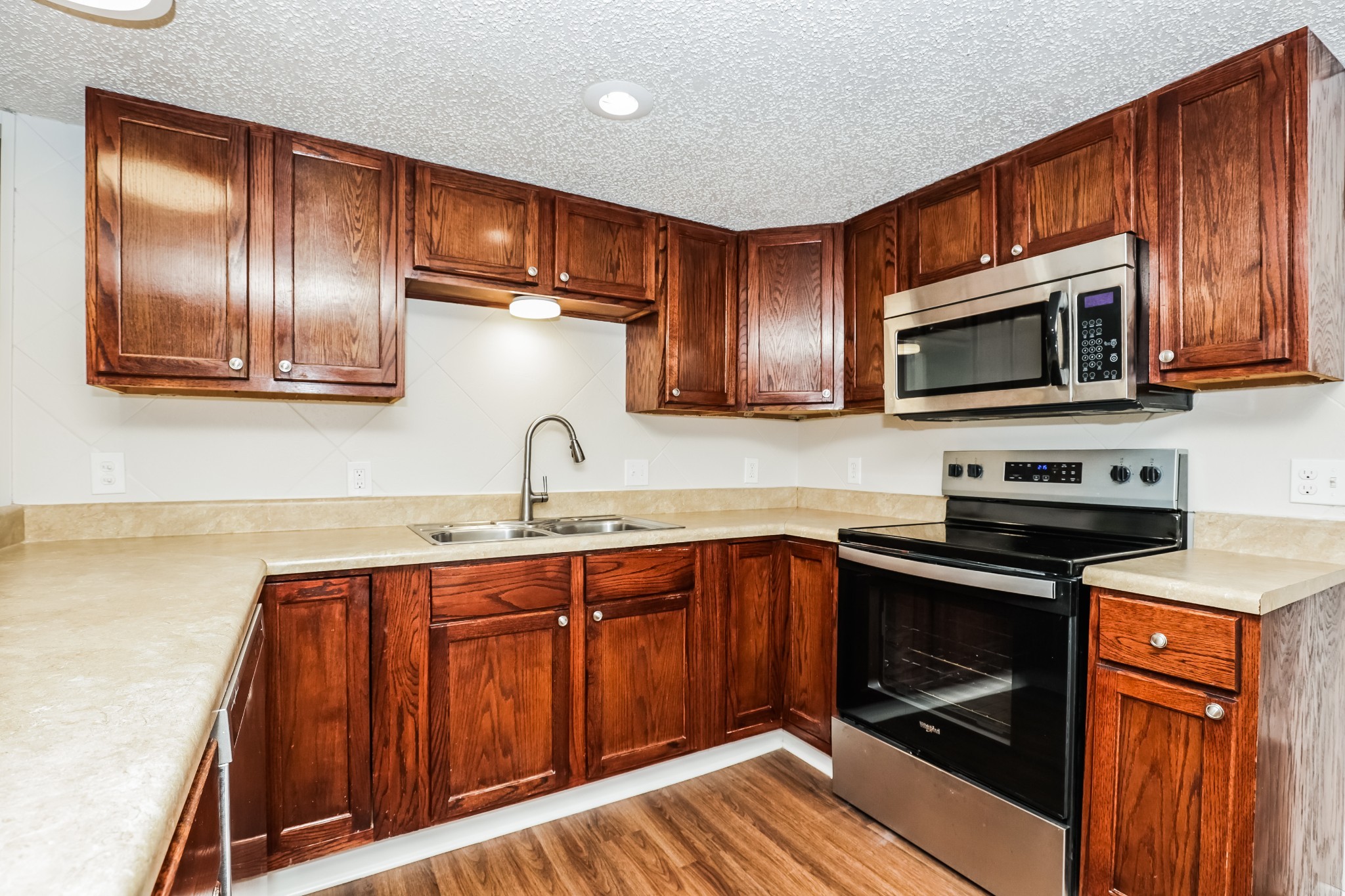 405 Montego Cove Hermitage, TN 37076 - Photo 6 of 16 a kitchen with stainless steel appliances granite countertop wooden cabinets a stove top oven a sink and dishwasher