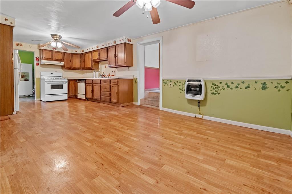322 Wilson Road Mount Morris, PA 15349 - Photo 14 of 26 a view of a kitchen with stainless steel appliances wooden floor and chandelier