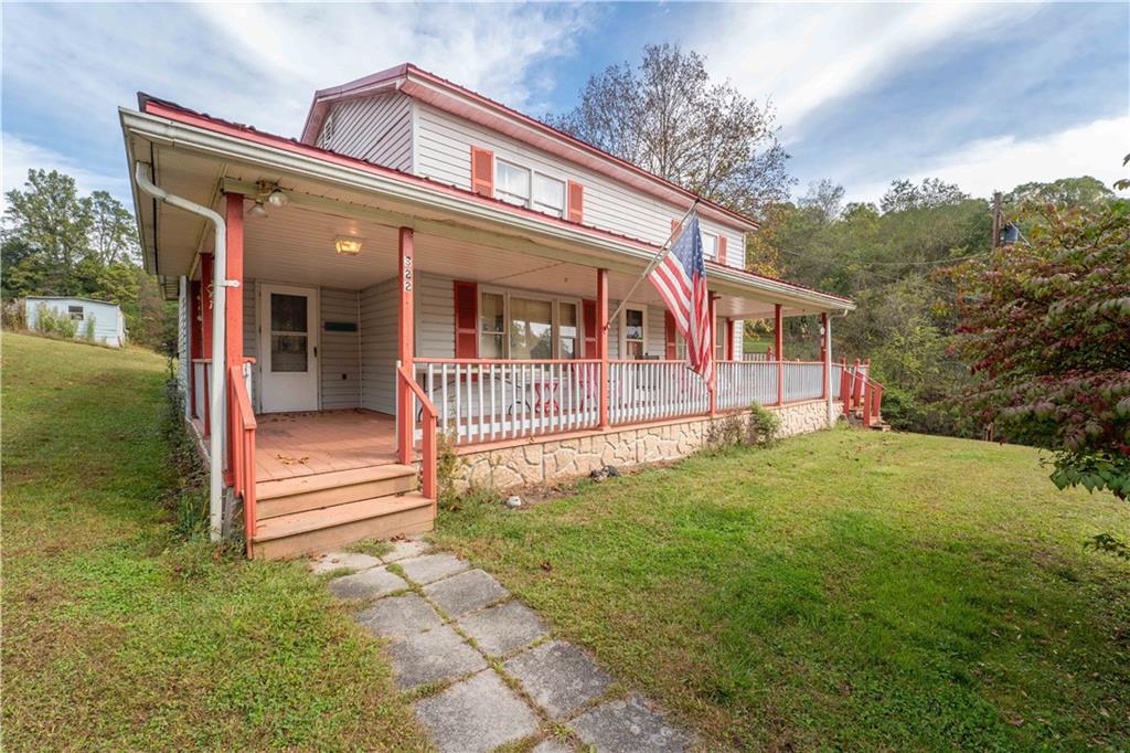 322 Wilson Road Mount Morris, PA 15349 - Photo 2 of 26 a front view of a house with a yard
