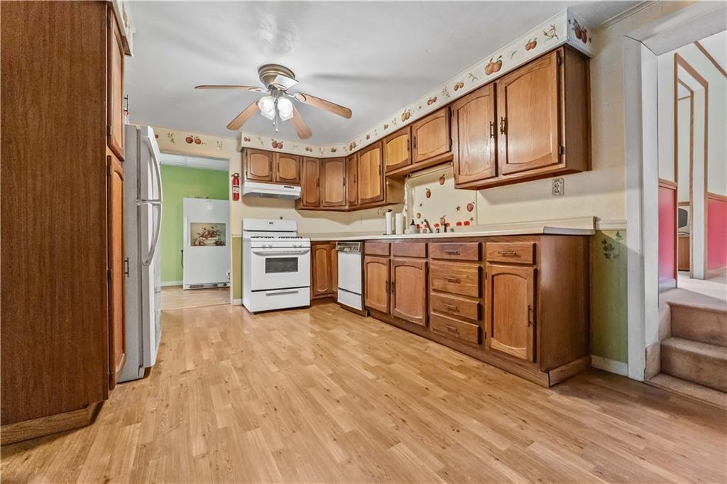 322 Wilson Road Mount Morris, PA 15349 - Photo 10 of 26 a view of a kitchen with stainless steel appliances granite countertop a stove and a refrigerator