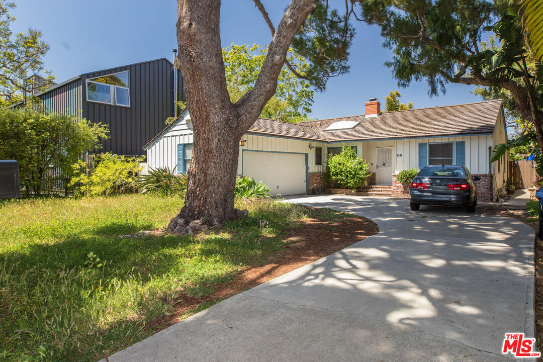 a car parked in front of white house
