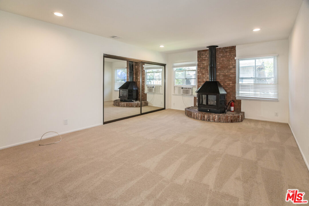 1341 Vienna Way Venice, CA 90291 - Photo 14 of 15 a view of empty room with a fireplace and large window