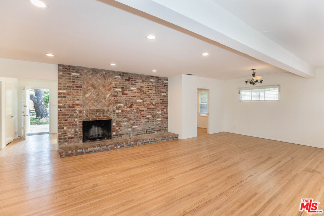 1341 Vienna Way Venice, CA 90291 - Photo 5 of 15 a view of empty room with wooden floor and fireplace