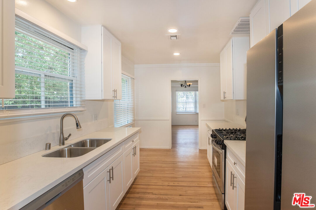 1341 Vienna Way Venice, CA 90291 - Photo 6 of 15 a kitchen with a sink stove and refrigerator