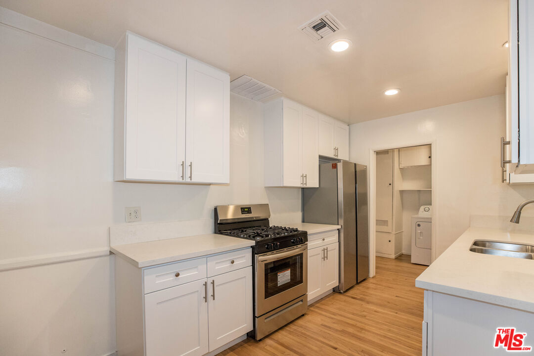 1341 Vienna Way Venice, CA 90291 - Photo 7 of 15 a kitchen with stainless steel appliances granite countertop a refrigerator sink and stove