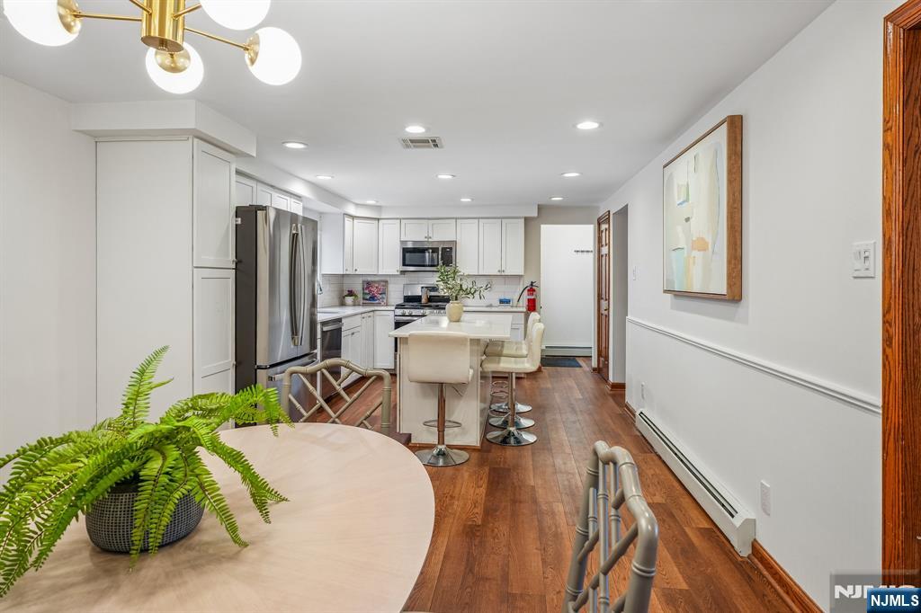 40 Golf Road Bloomfield, NJ 07003 - Photo 11 of 50 a view of a dining room with furniture a kitchen and chandelier