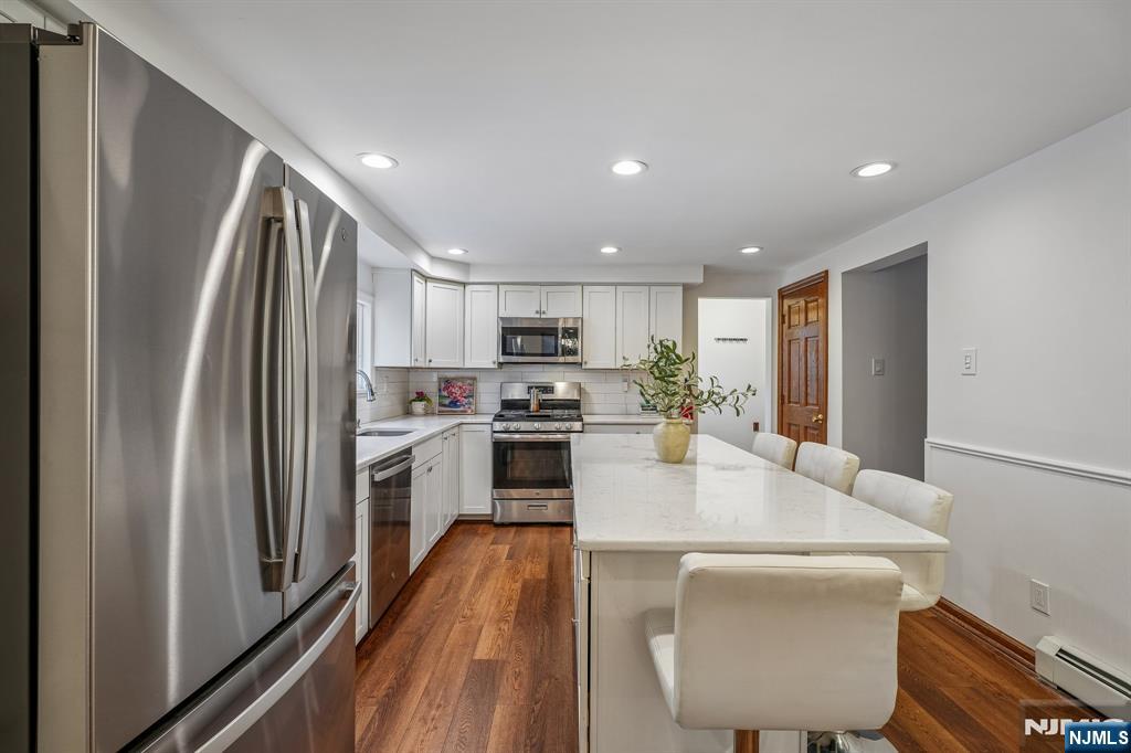 40 Golf Road Bloomfield, NJ 07003 - Photo 12 of 50 a kitchen with stainless steel appliances granite countertop a refrigerator a stove top oven a sink and dishwasher