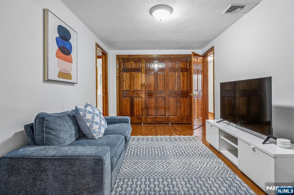 40 Golf Road Bloomfield, NJ 07003 - Photo 26 of 50 a living room with furniture and a flat screen tv