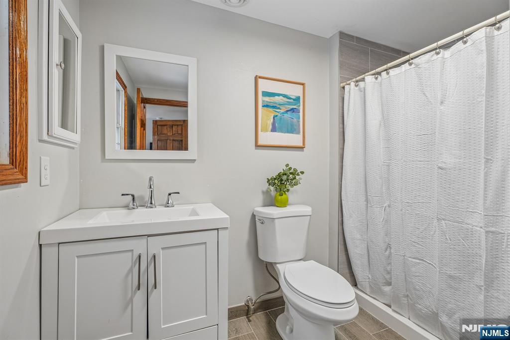 40 Golf Road Bloomfield, NJ 07003 - Photo 30 of 50 a bathroom with a toilet sink and mirror