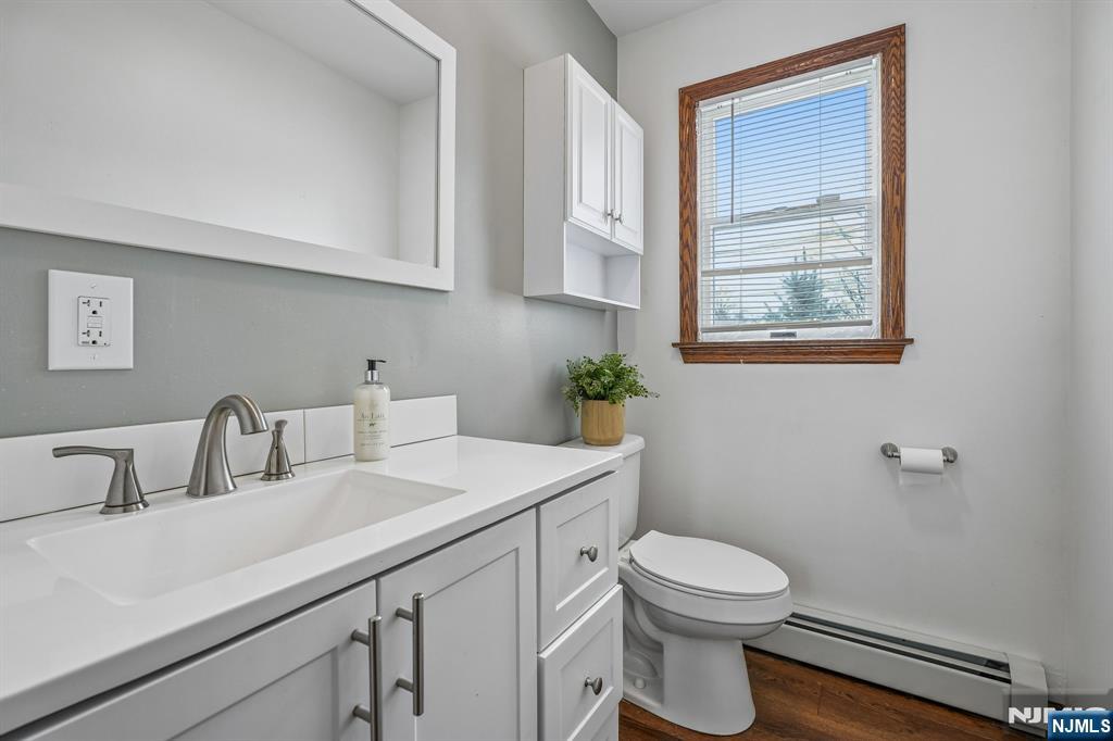 40 Golf Road Bloomfield, NJ 07003 - Photo 40 of 50 a bathroom with a toilet a sink and a window