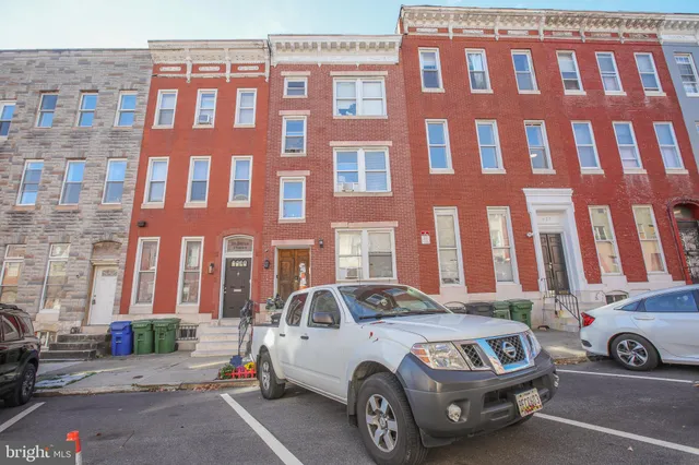 a front view of a building with parking space