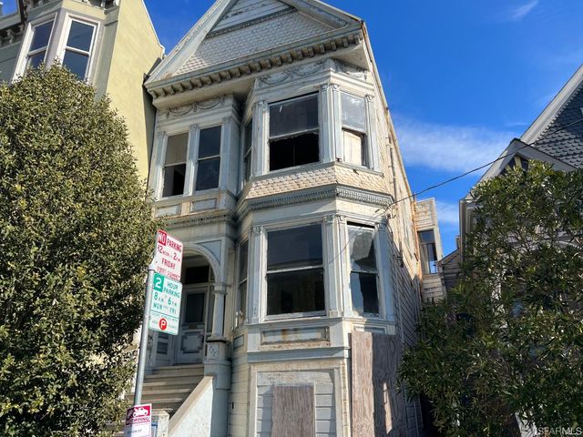 a view of a white building with many windows