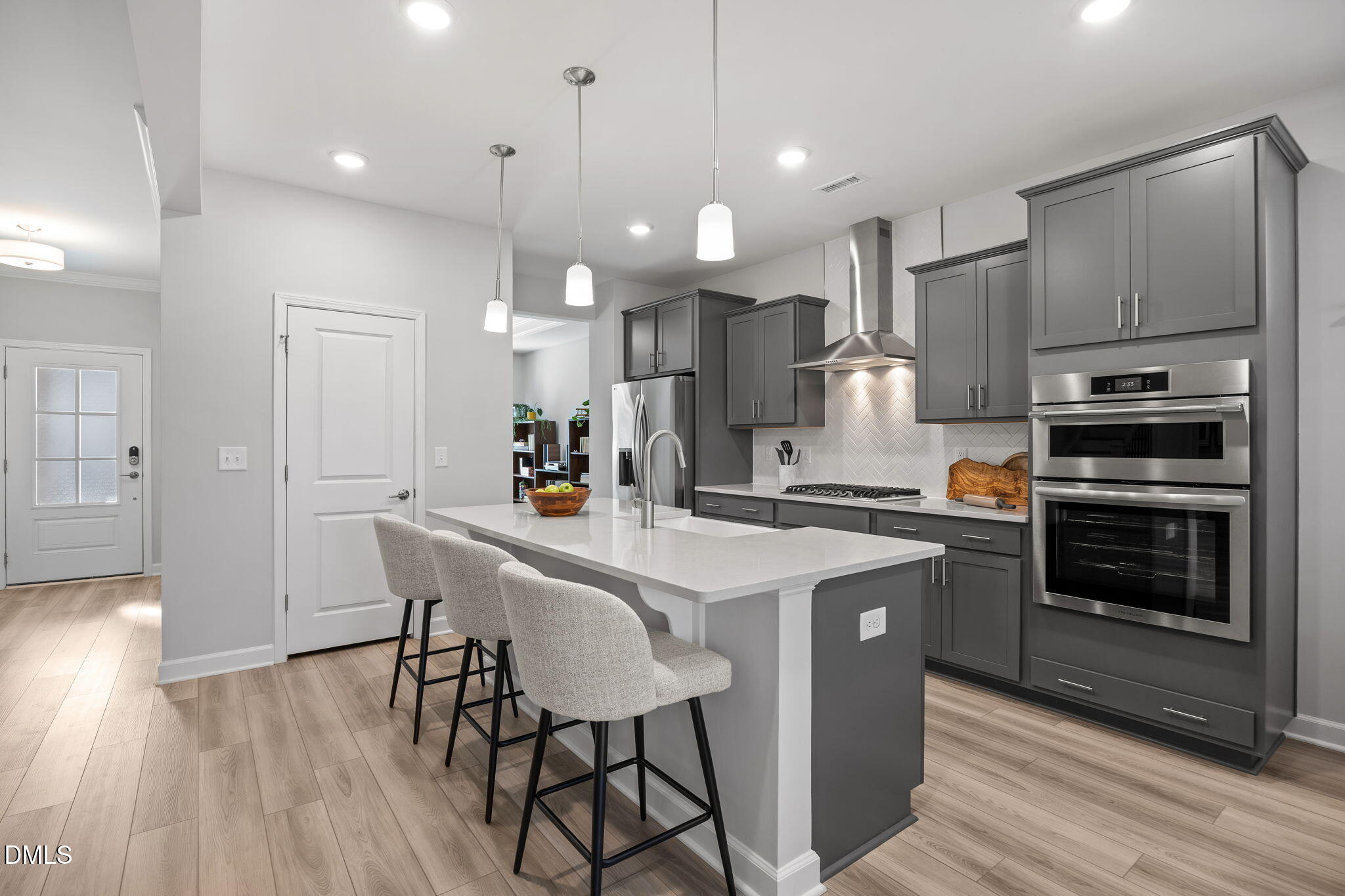 321 Pond Overlook Court Knightdale, NC 27545 - Photo 12 of 41 a kitchen with stainless steel appliances a dining table chairs stove and refrigerator