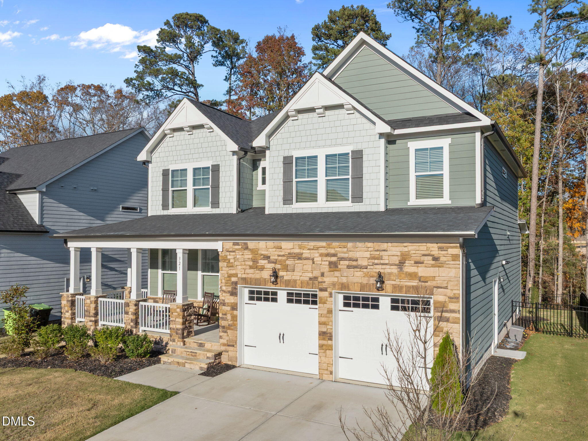321 Pond Overlook Court Knightdale, NC 27545 - Photo 40 of 41 a view of a white house with large windows and a small yard