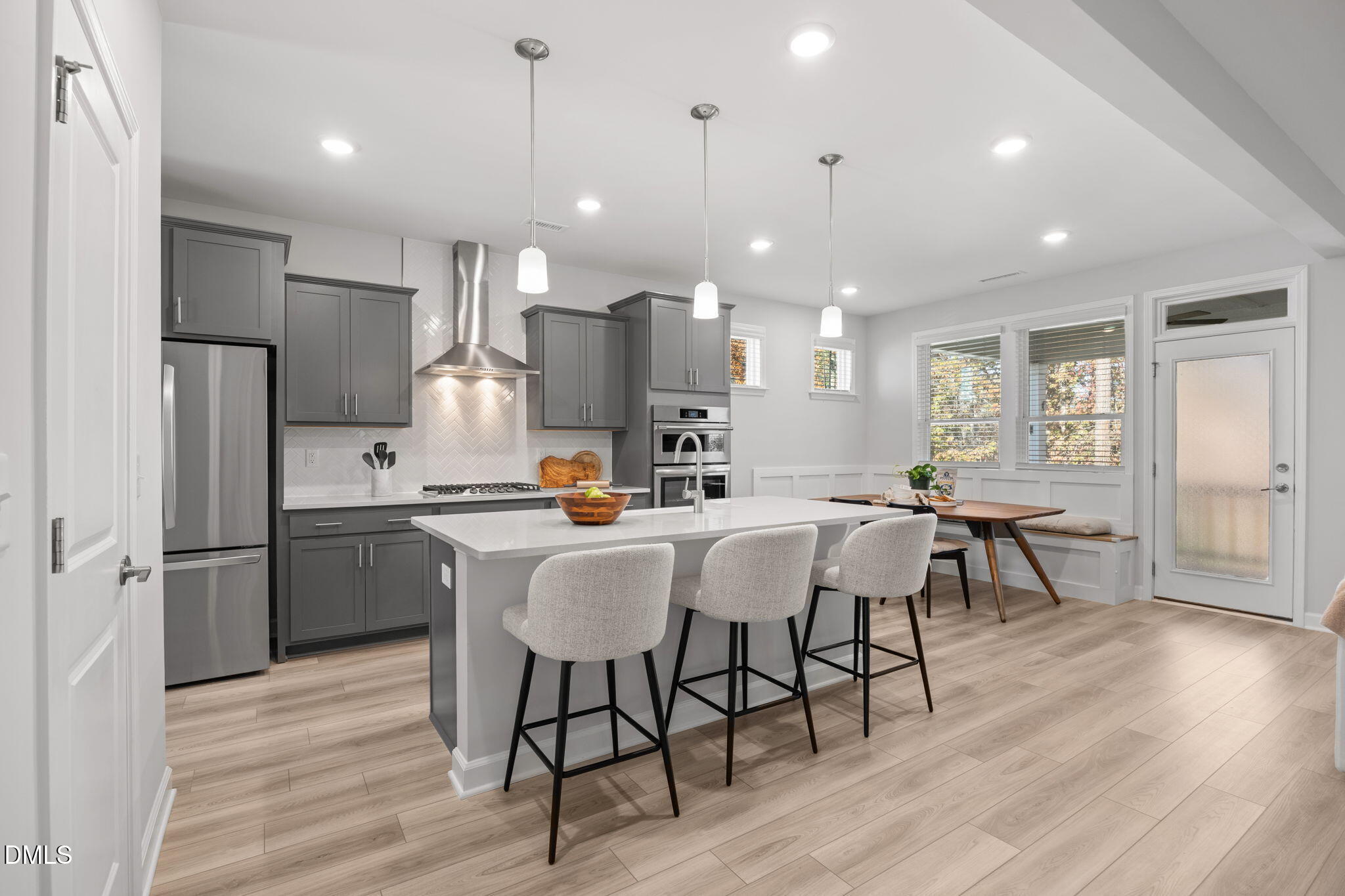 321 Pond Overlook Court Knightdale, NC 27545 - Photo 8 of 41 a kitchen with a dining table chairs refrigerator and cabinets