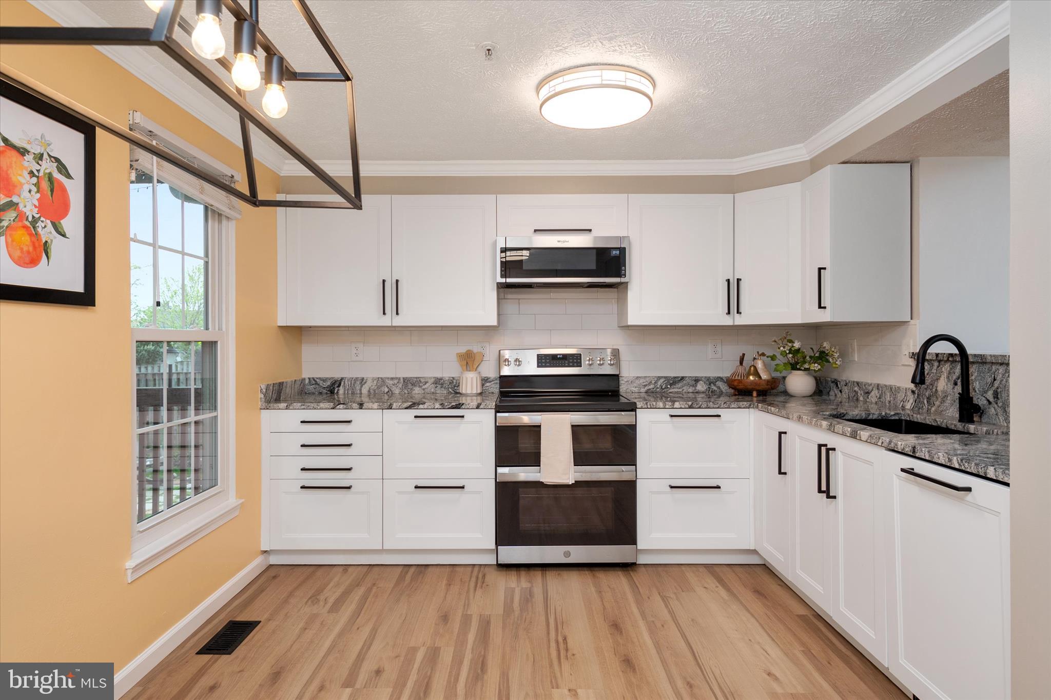 2275 Lea Court Odenton, MD 21113 - Photo 11 of 55 a kitchen with granite countertop a stove and a sink