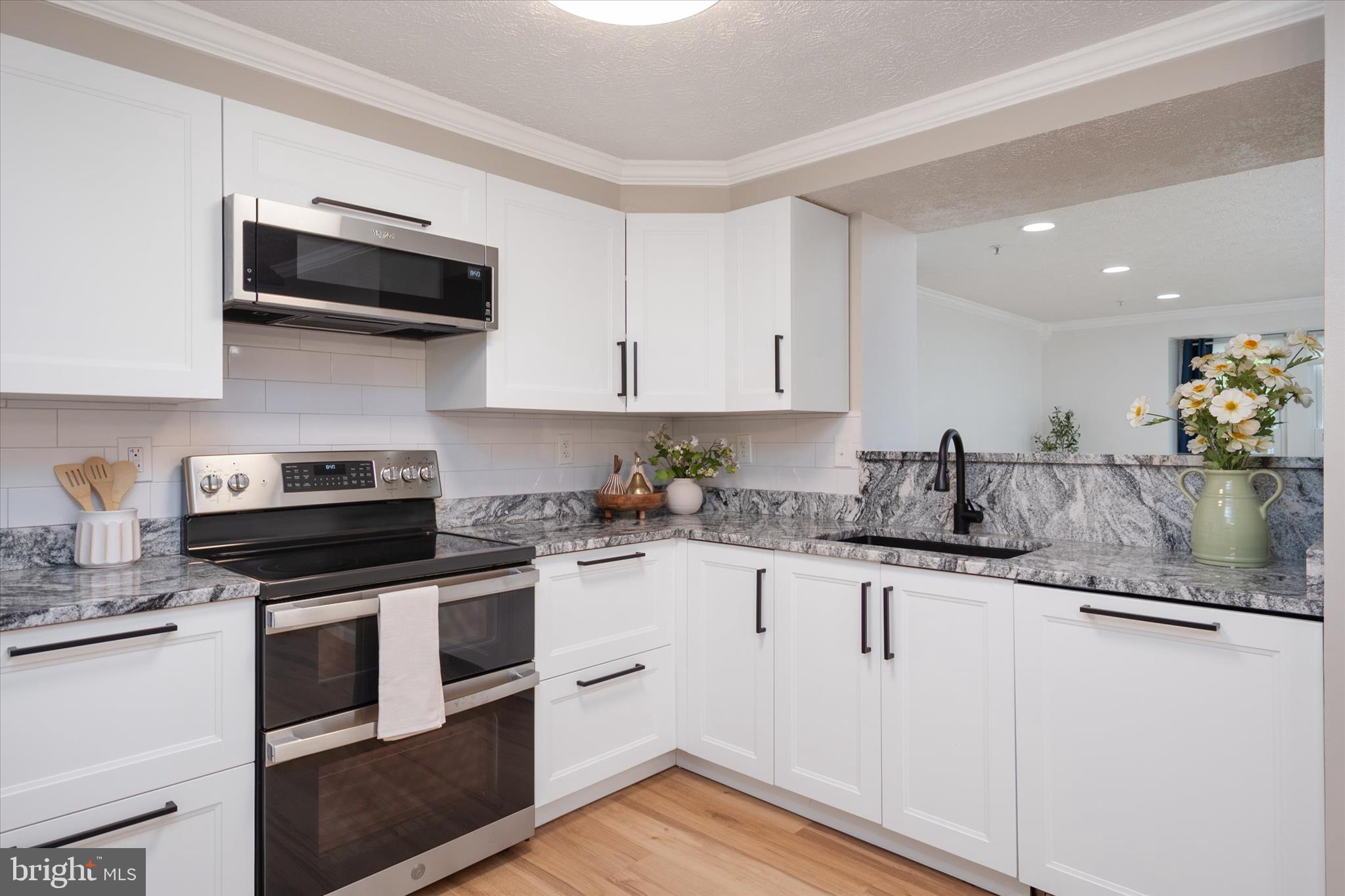 2275 Lea Court Odenton, MD 21113 - Photo 12 of 55 a kitchen with granite countertop a sink and steel appliances