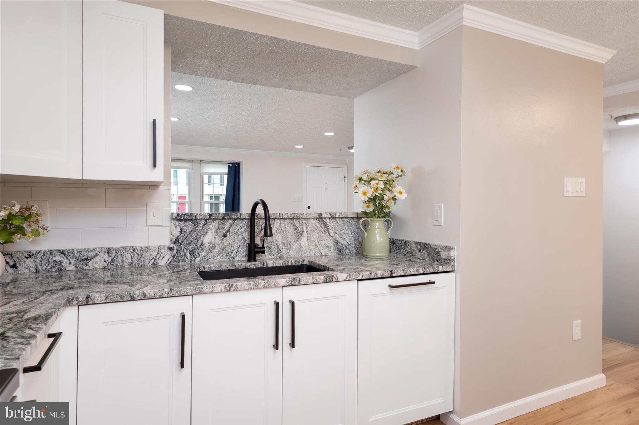 2275 Lea Court Odenton, MD 21113 - Photo 13 of 55 a kitchen with granite countertop a sink and cabinets