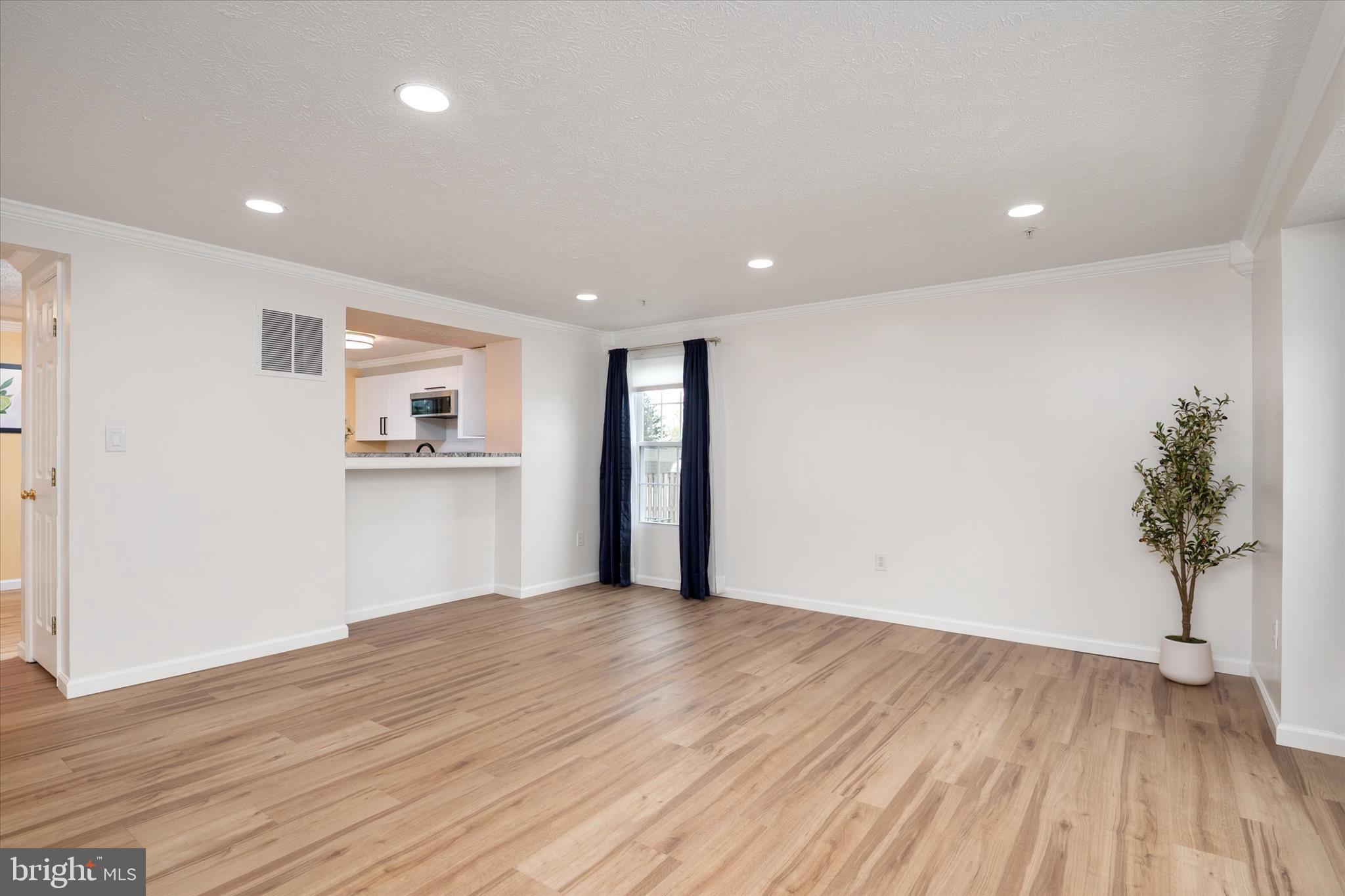 2275 Lea Court Odenton, MD 21113 - Photo 4 of 55 a view of empty room with wooden floor and kitchen
