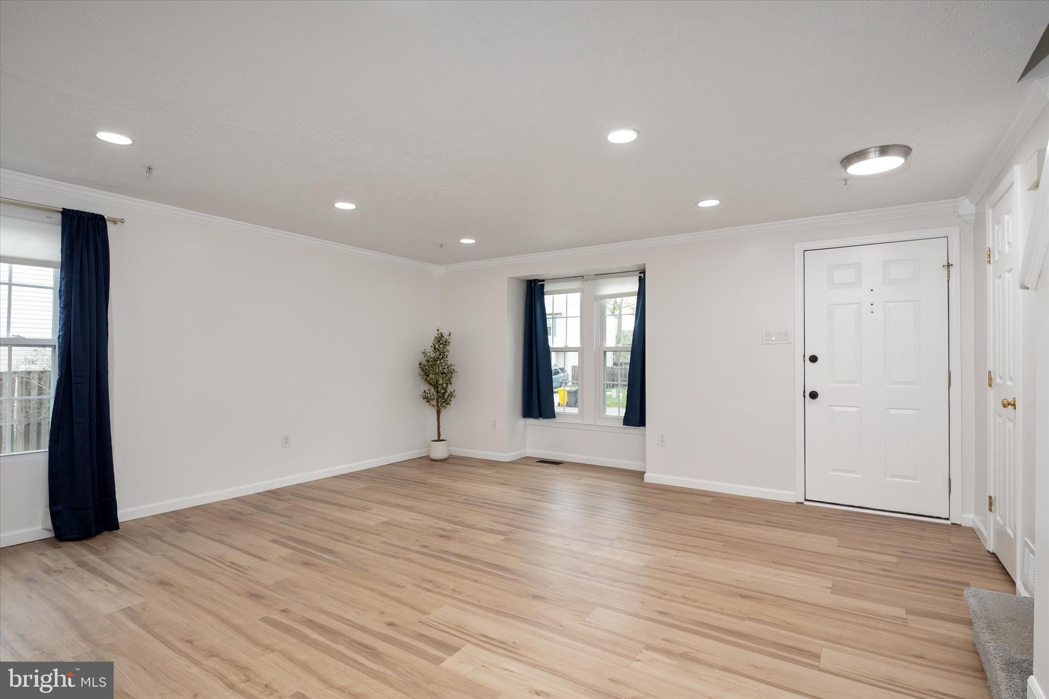 2275 Lea Court Odenton, MD 21113 - Photo 6 of 55 a view of an empty room with wooden floor and a window