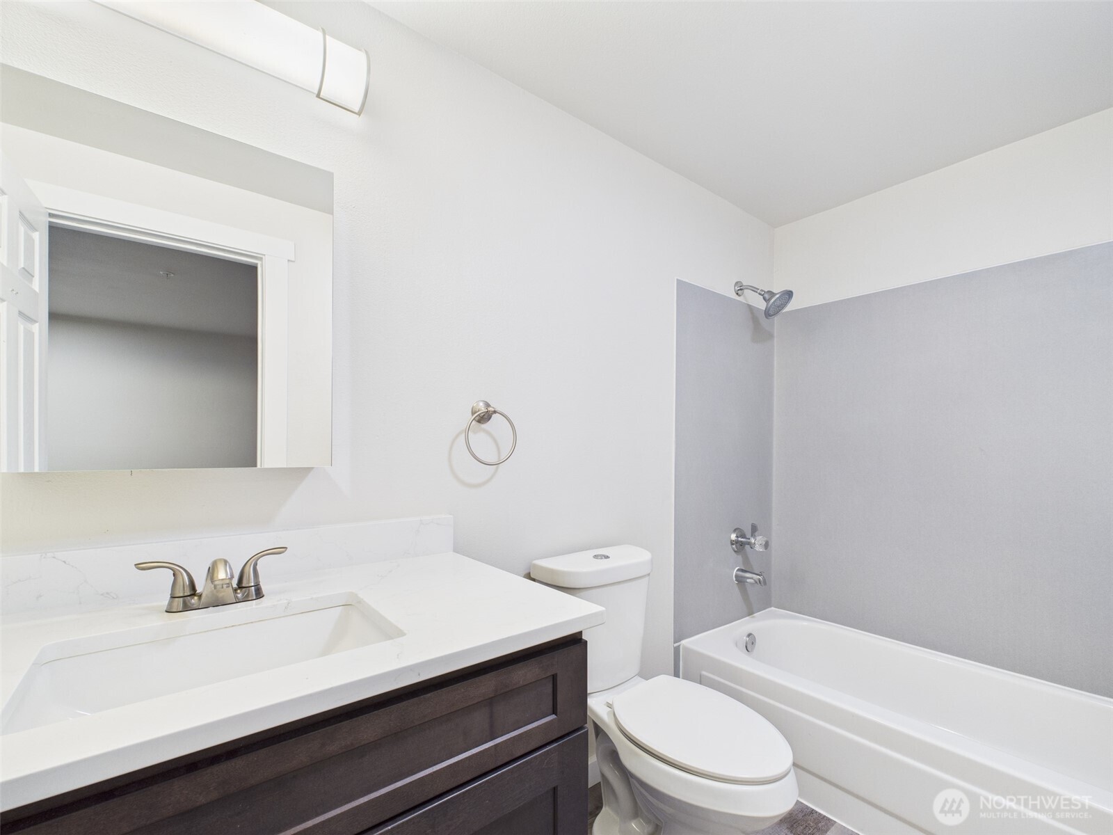 29645 18th Avenue South, Unit A301 Federal Way, WA 98003 - Photo 16 of 24 a bathroom with a sink a toilet and shower