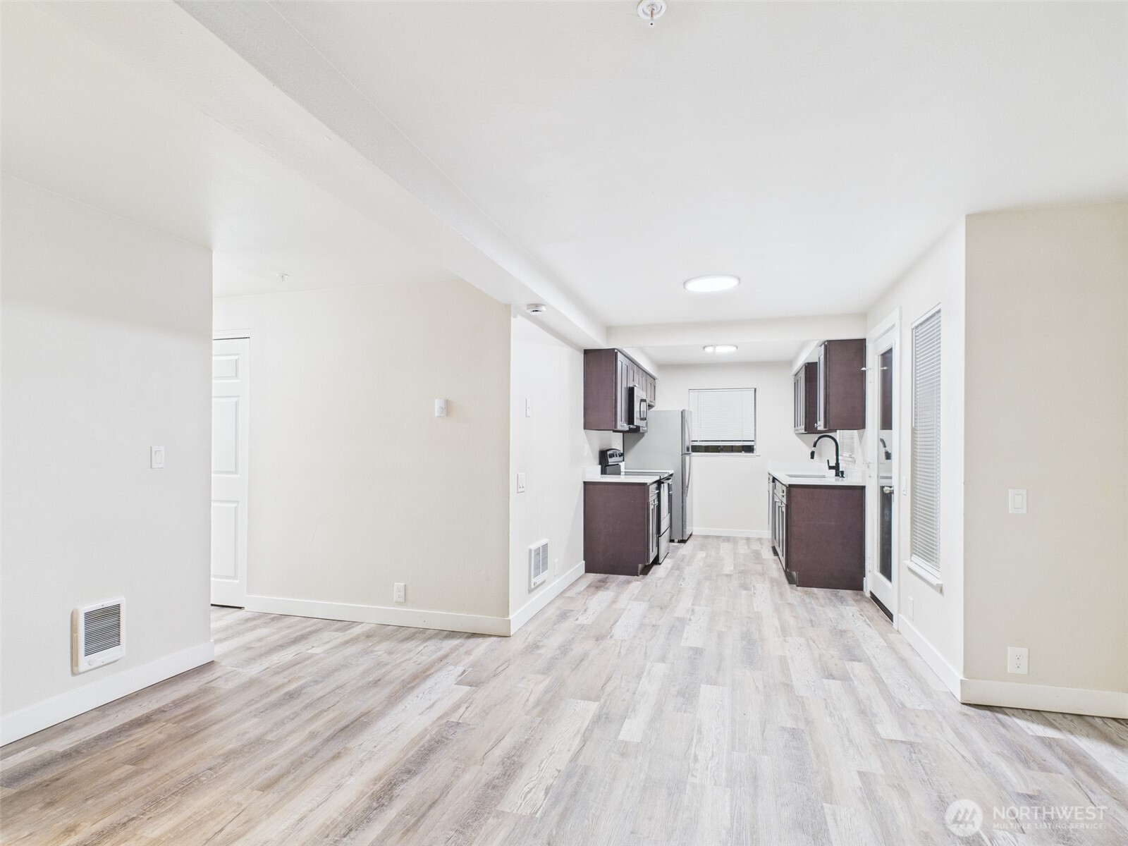 29645 18th Avenue South, Unit A301 Federal Way, WA 98003 - Photo 2 of 24 a view of a kitchen with a sink and wooden floor