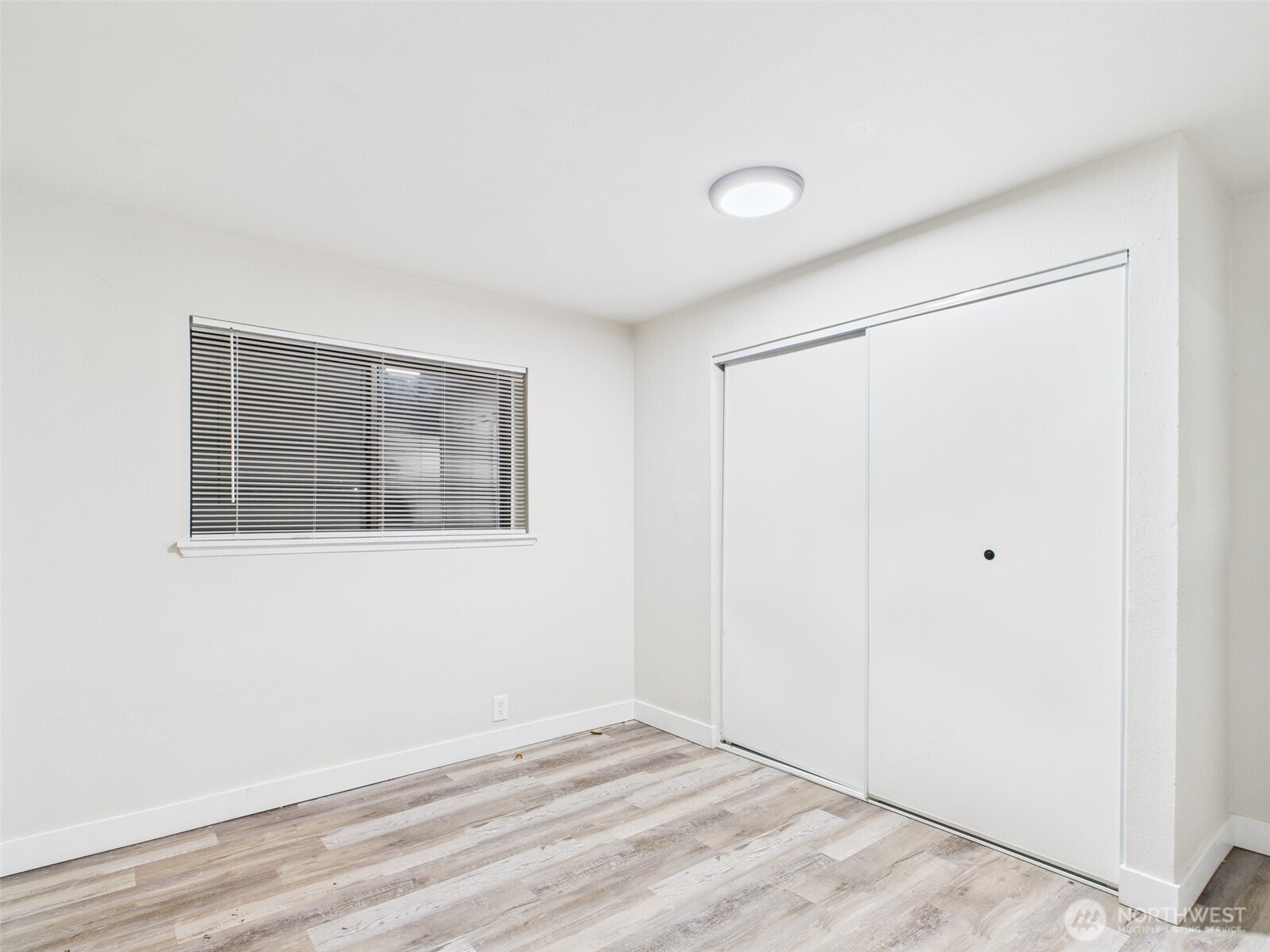 29645 18th Avenue South, Unit A301 Federal Way, WA 98003 - Photo 22 of 24 a view of an empty room with wooden floor and a window