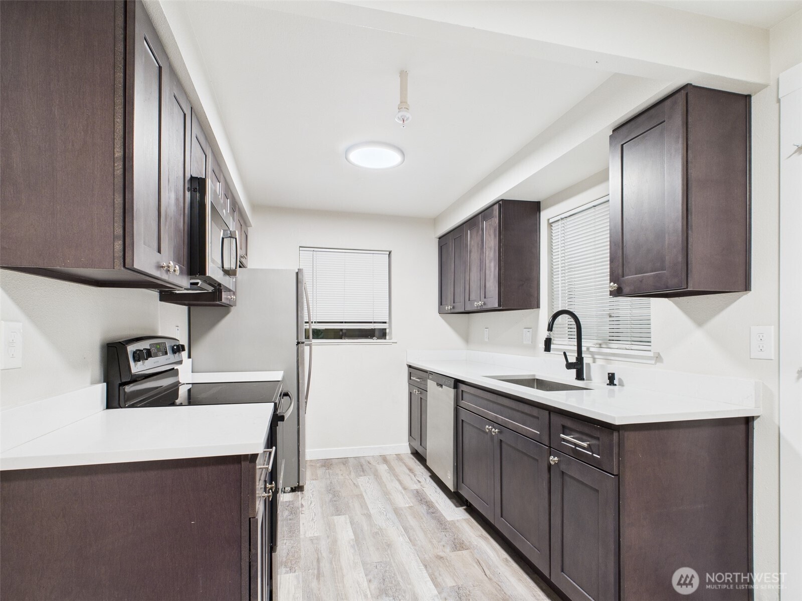 29645 18th Avenue South, Unit A301 Federal Way, WA 98003 - Photo 3 of 24 a kitchen with a sink cabinets and appliances