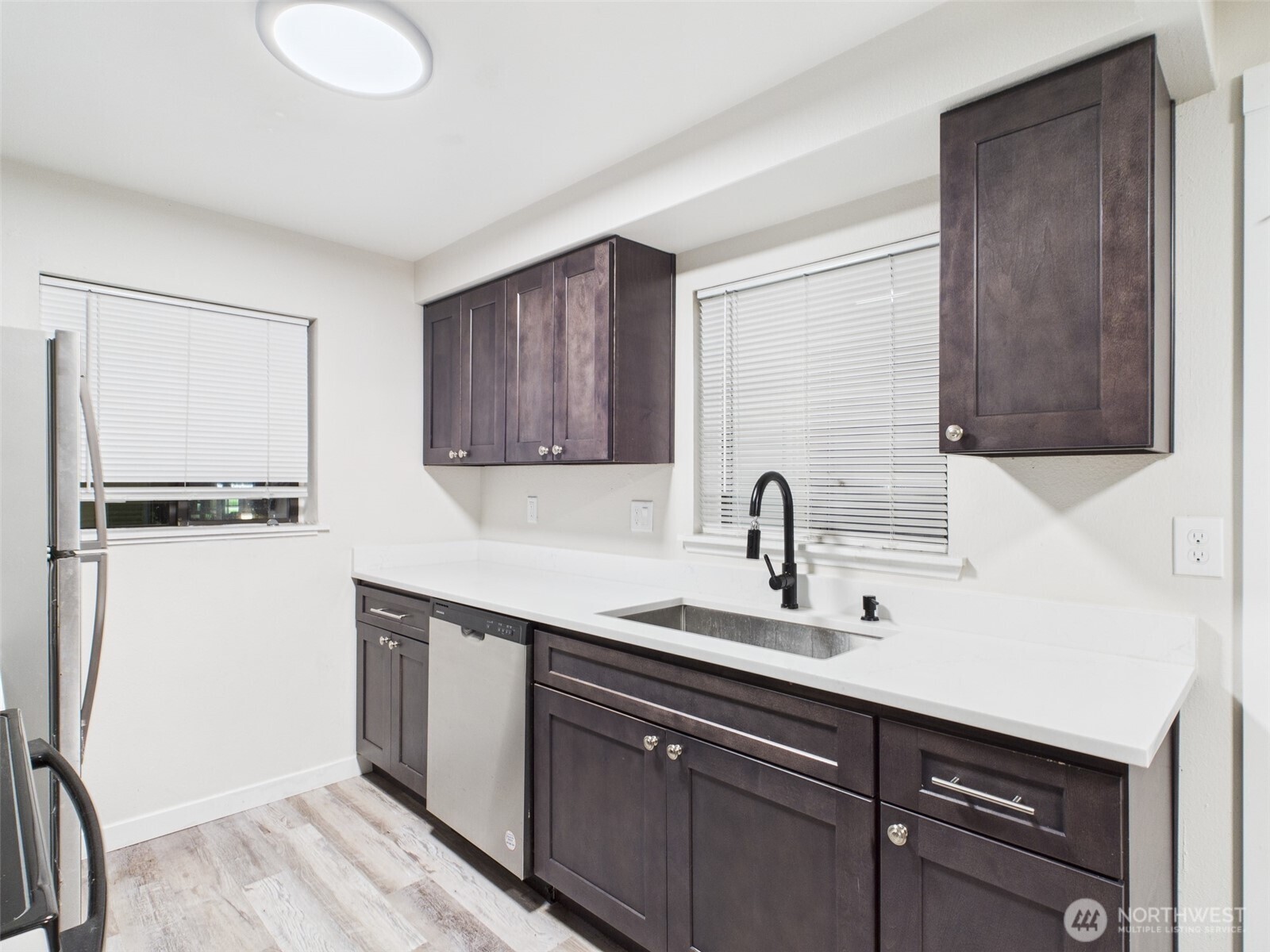 29645 18th Avenue South, Unit A301 Federal Way, WA 98003 - Photo 4 of 24 a kitchen with a sink and cabinets
