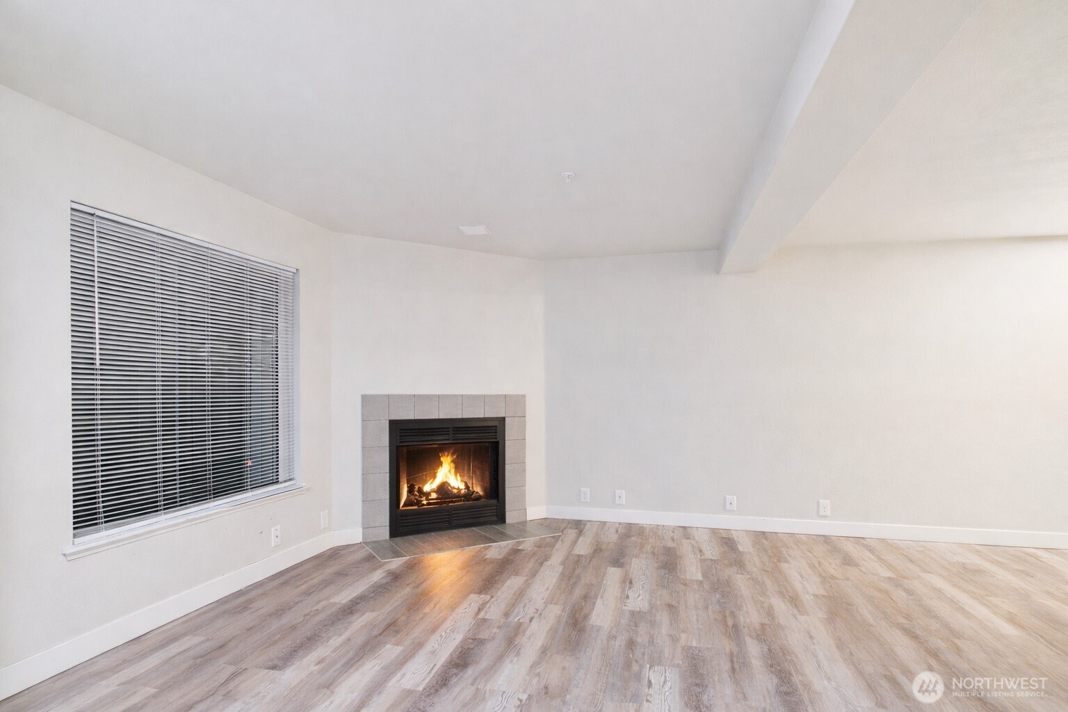 29645 18th Avenue South, Unit A301 Federal Way, WA 98003 - Photo 8 of 24 a view of an empty room with a fireplace and wooden floor