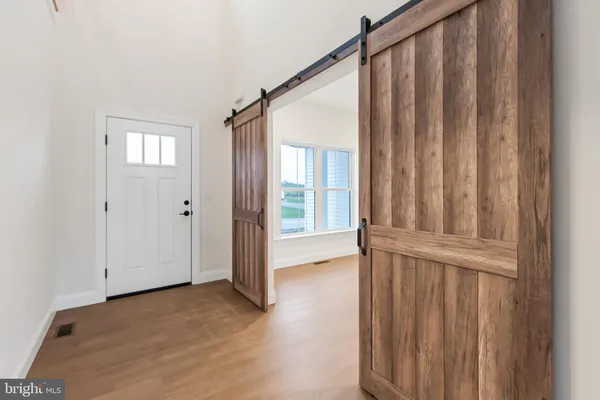 a view of front door with wooden floor
