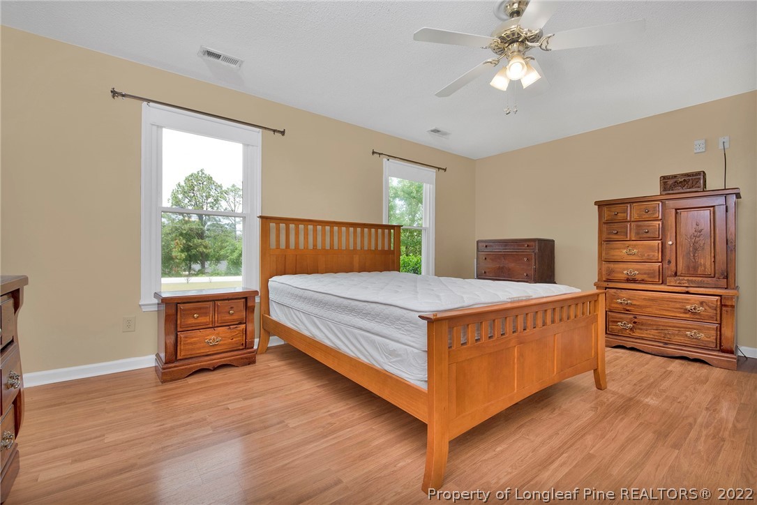 22 Woodridge Lane Cameron, NC 28326 - Photo 14 of 33 a bedroom with a bed and wooden floor