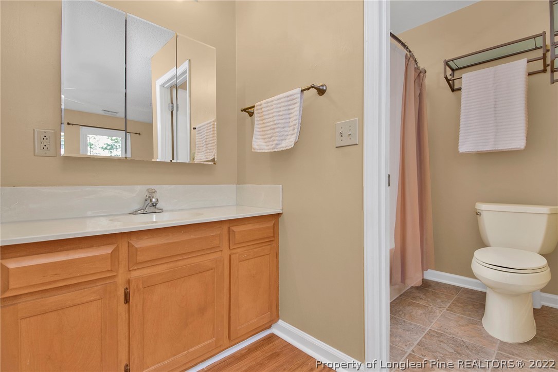 22 Woodridge Lane Cameron, NC 28326 - Photo 15 of 33 a bathroom with a toilet sink vanity and mirror