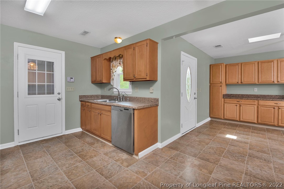 22 Woodridge Lane Cameron, NC 28326 - Photo 19 of 33 a kitchen with a stove a sink and a refrigerator