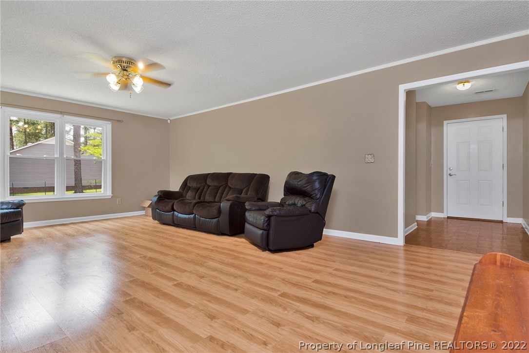22 Woodridge Lane Cameron, NC 28326 - Photo 20 of 33 a living room with furniture and a chandelier