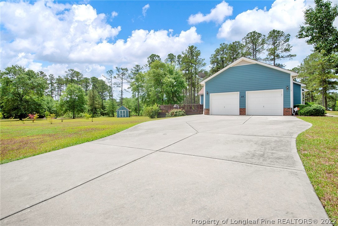 22 Woodridge Lane Cameron, NC 28326 - Photo 21 of 33 a front view of a house with a yard and garage