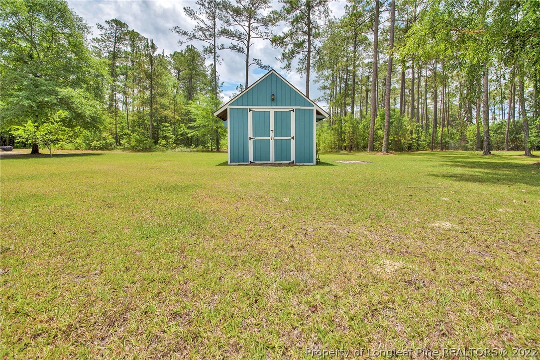 22 Woodridge Lane Cameron, NC 28326 - Photo 26 of 33 a front view of a house with a yard