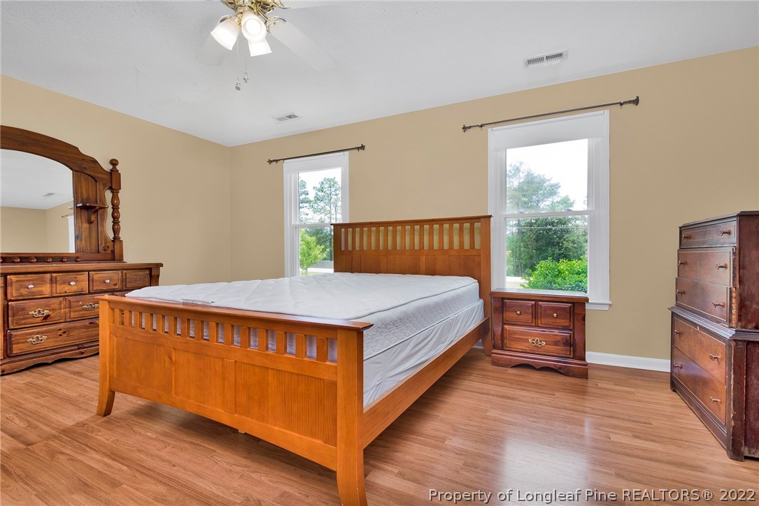 22 Woodridge Lane Cameron, NC 28326 - Photo 29 of 33 a spacious bedroom with a bed and a flat screen tv