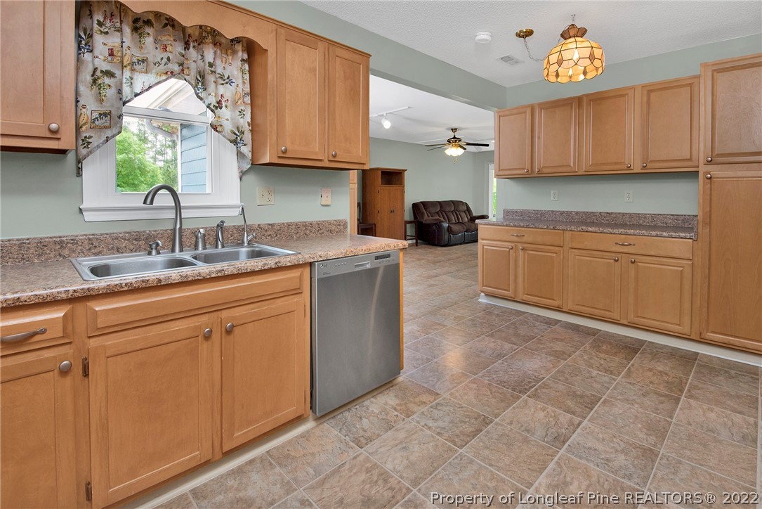 22 Woodridge Lane Cameron, NC 28326 - Photo 30 of 33 a kitchen with stainless steel appliances granite countertop a sink and a stove